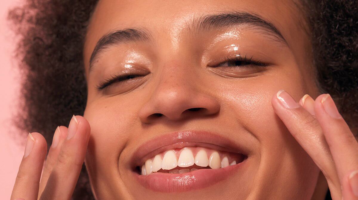 Close up of smiling model's face with glowing skin