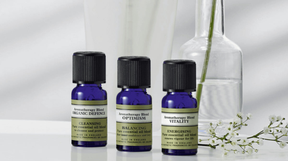 3 bottles of Neal's Yard Remedies Essential Oils on a table