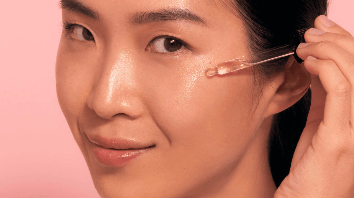 Close up of Asian model applying an eyecare product around her eye area