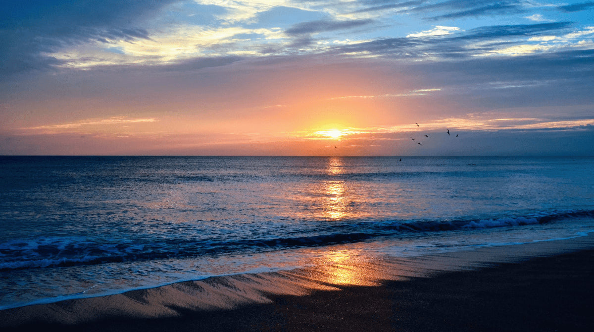 Colourful sunset on the beach with gentle waves