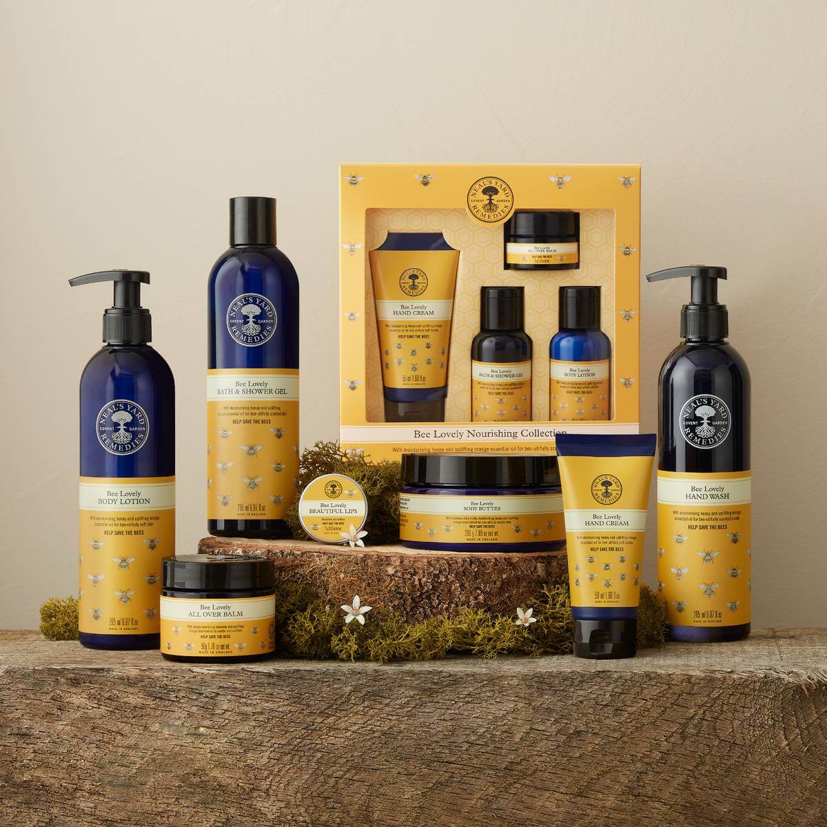 Picture of the Bee Lovely body care range displayed on rustic wood by Neal's Yard Remedies