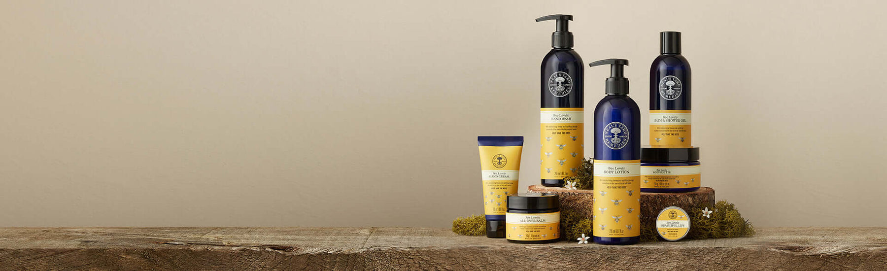 Picture of the Bee Lovely body care range displayed on rustic wood by Neal's Yard Remedies