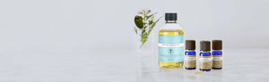 PIcture of the Create Your Own Massage Oil and three essential oils by Neal's Yard Remedies