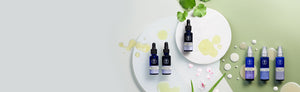 Picture displaying different facial oils and serums on green and white background by Neal's Yard Remedies